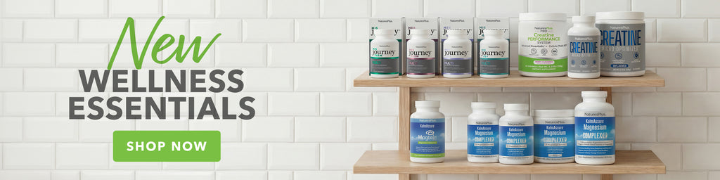 Shop New Wellness Essentials. Banner featuring various Natures Plus supplement bottles on wooden shelves.